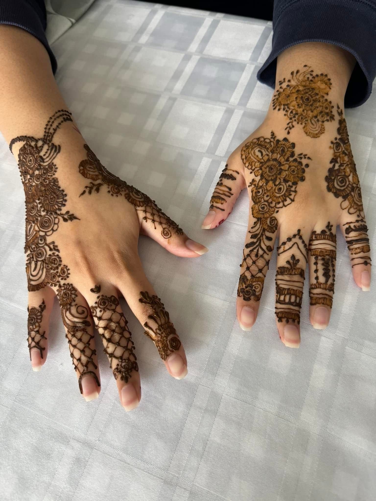 Regular mehndi design featuring intricate floral and geometric henna patterns on both hands, traditional henna art for casual and festive occasions.
